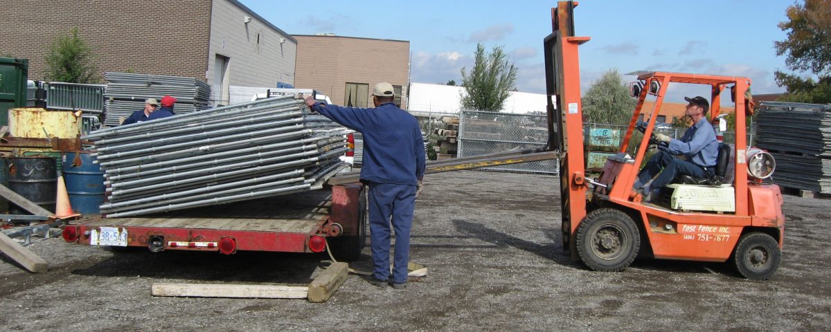 Loading fence onto trailer in yard